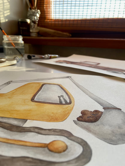 A close-up of a watercolor painting on paper depicting a yellow vehicle or boat section with gray and brown details, photographed on a desk with paintbrushes, jars, and another drawing in a sunlit room.