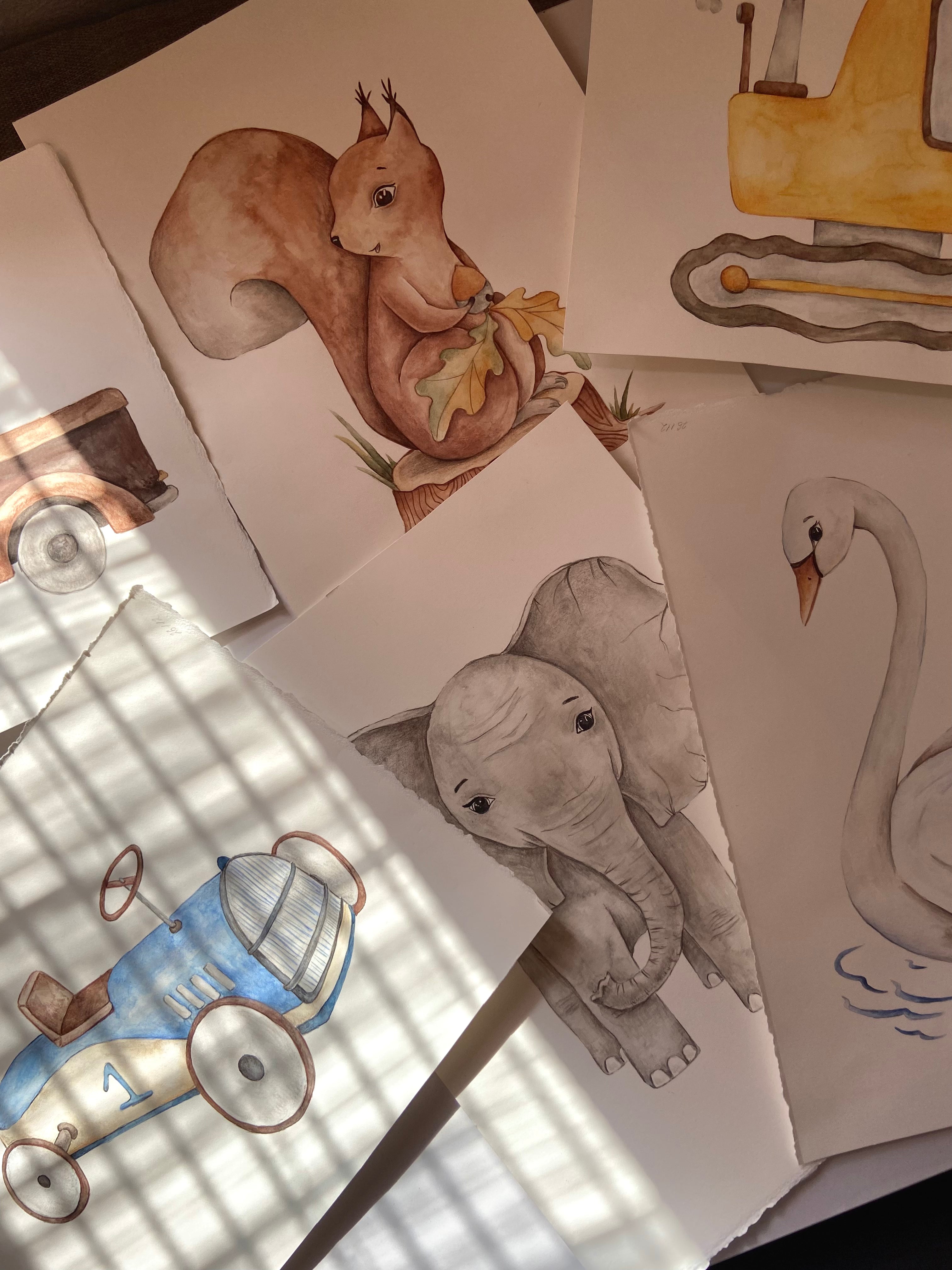 A collection of hand-drawn watercolor illustrations on paper, featuring a brown squirrel, a gray elephant, a white swan, a blue and white toy car, and a yellow vehicle, arranged on a surface with dappled sunlight.